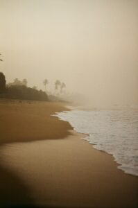 A sandy beach with waves coming in to shore