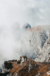 Misty mountains peeking through the clouds.